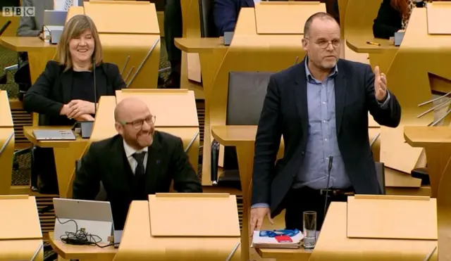 Mr Tomkins refuses interventions from both Patrick Harvie and Andy Wightman