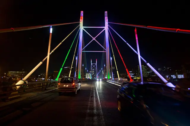 Nelson Mandela Bridge lit up at night,