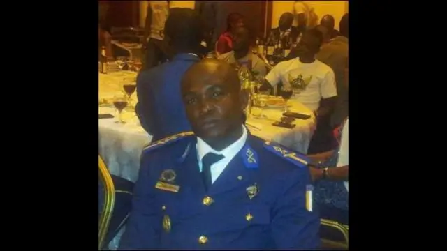 Lt Kelly Ondo Obiang sits on a chair wearing his military uniform