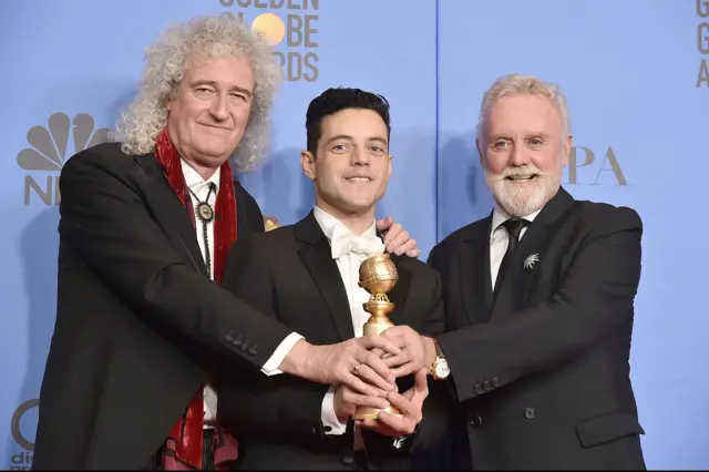 Rami Malek (c) with Queen's Brian may (l) and Roger Taylor