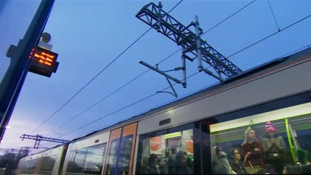 One of the diesel trains under the electric power lines