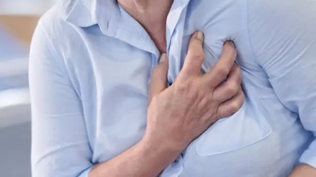 Woman grasping her heart