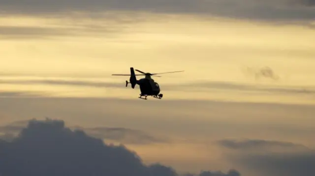 A police helicopter flying through the sky