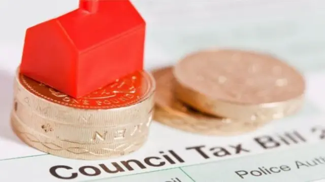 Council tax bill, house model and coins