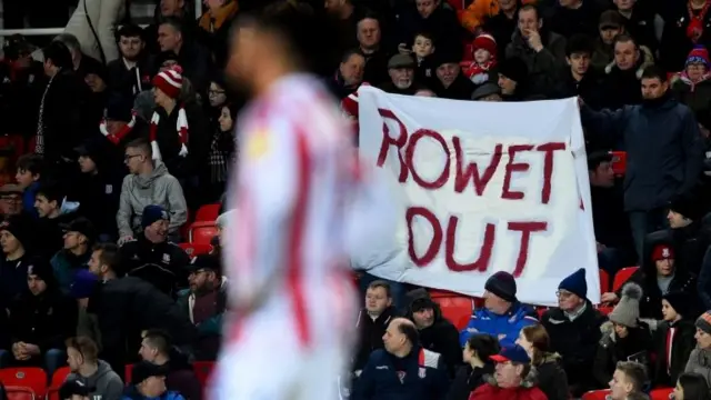 Fans display a Rowett Out banner