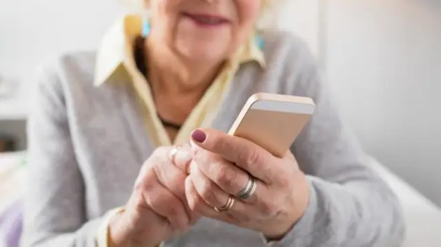 Elderly person using phone