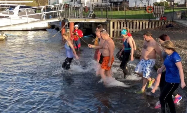 Swimmers entering water