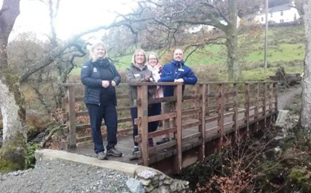 National Park ranger and people from HF Holidays on one of the restored bridges