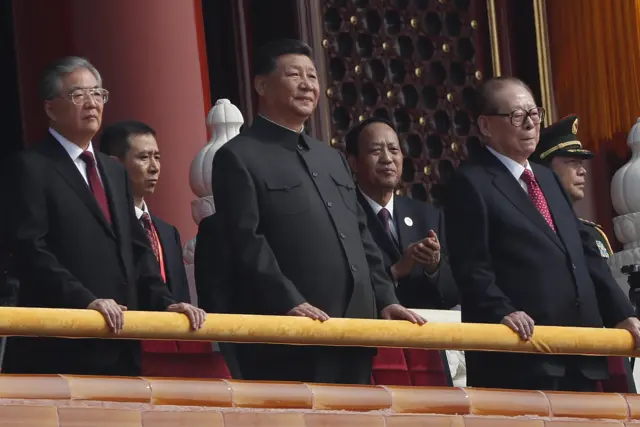 Xi Jinping (centre) on the podium in Tiananmen Square