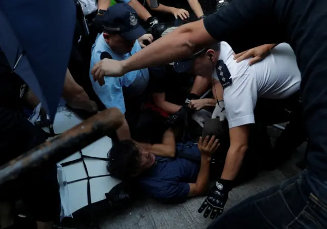 Police detain a protester in Hong Kong on 1 October