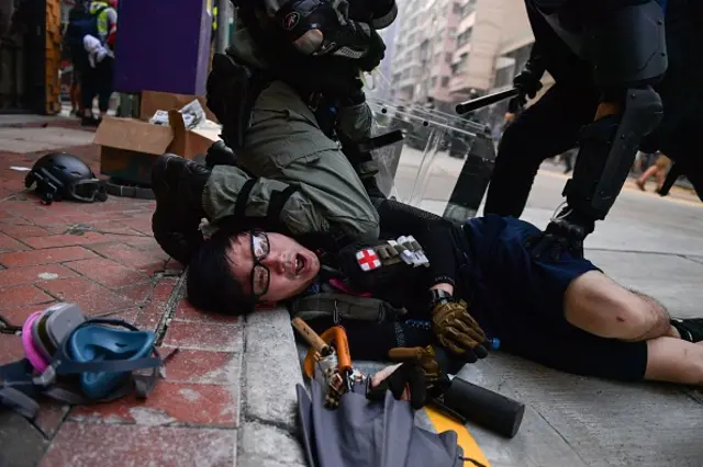 Police detain a protester