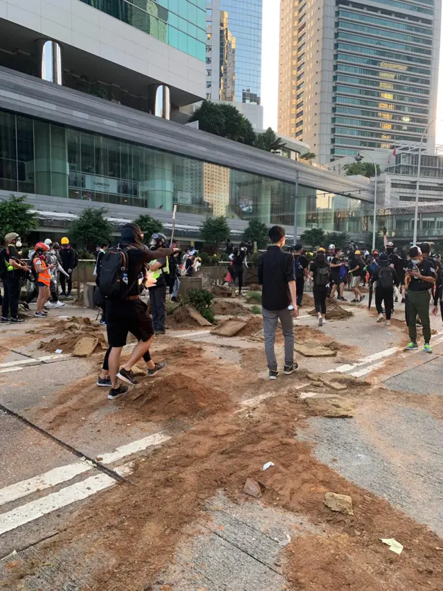 Protesters digging up planters