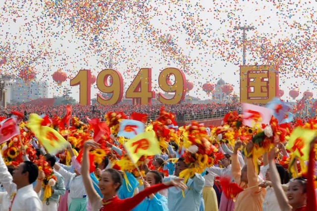 Balloons are seen above performers at the end of the parade marking the 70th founding anniversary of People"s Republic of China