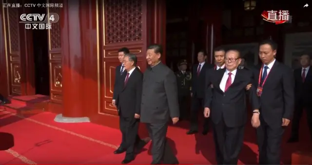 A screengrab of CCTV footage showing Xi Jinping flanked by Jiang Zemin and Hu Jintao