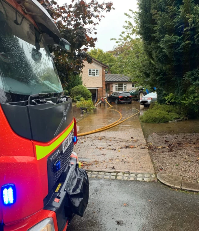 Fire engine pumping out houses