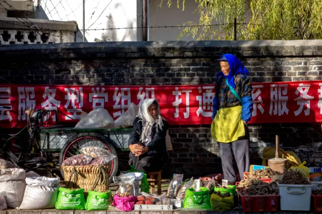 Women at a market stall in China