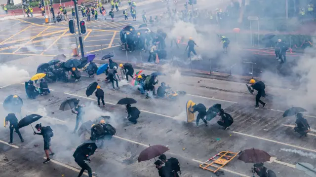 Protesters stand off against riot police in Hong Kong