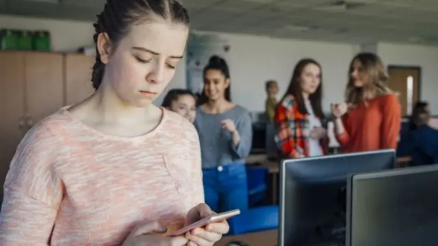 A young person on her mobile phone