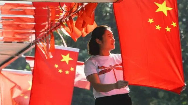 Woman putting up Chinese flag