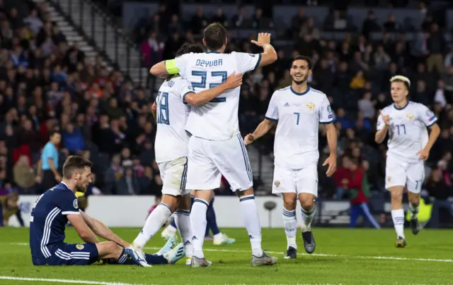 Russia celebrate Stephen O'Donnell's own goal at Hampden