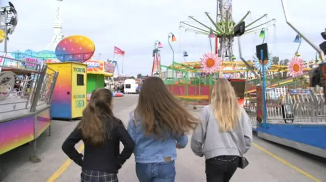 Three young people at the fair