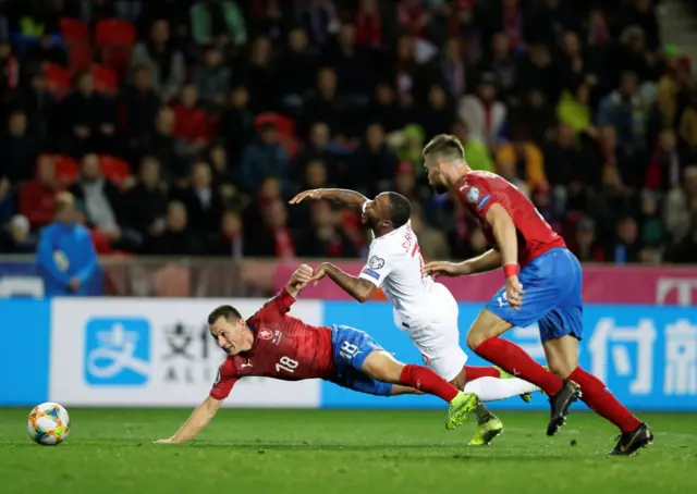 England's Raheem Sterling goes down under the challenge of Czech Republic's Jan Boril in the penalty area