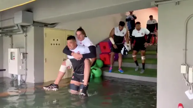 Japan players wading through water