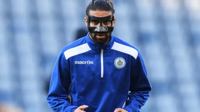 A San Marino player trains in a face mask