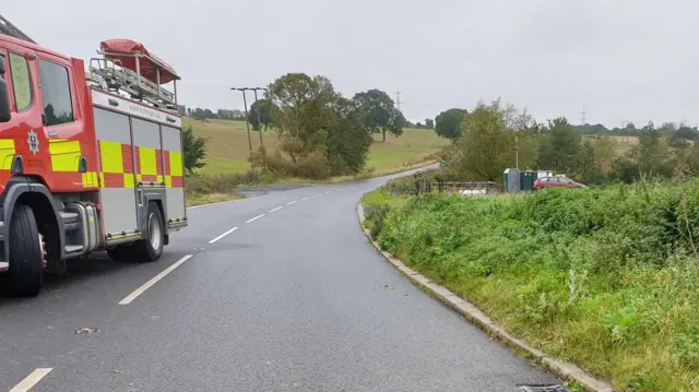 A fire engine on a road at the scene of the crash