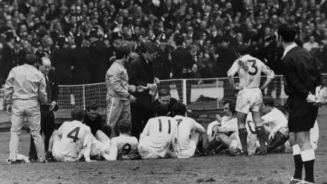 Leeds United manager Don Revie (centre, kneeling) talks to team before extra time during FA Cup against Chelsea at Wembley in 1970