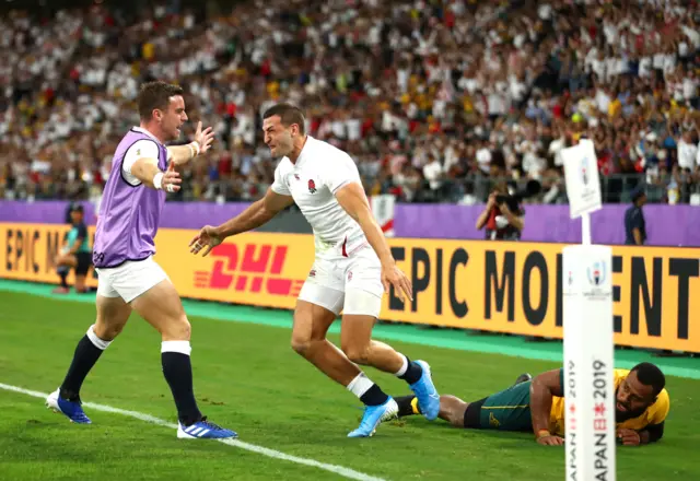 Jonny May of England celebrates with team mate George Ford after scoring his team"s second try during the Rugby World Cup 2019 Quarter Final match between England and Australia at Oita Stadium