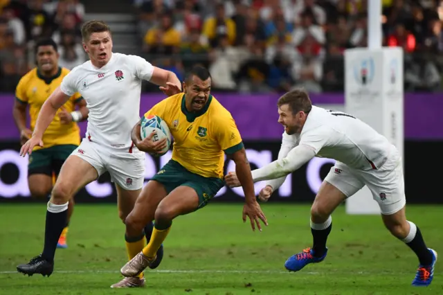 Australia"s full back Kurtley Beale (C) runs past England"s fly-half Owen Farrell (L) and England"s full back Elliot Daly during the Japan 2019 Rugby World Cup quarter-final match between England and Australia at the Oita Stadium in Oita