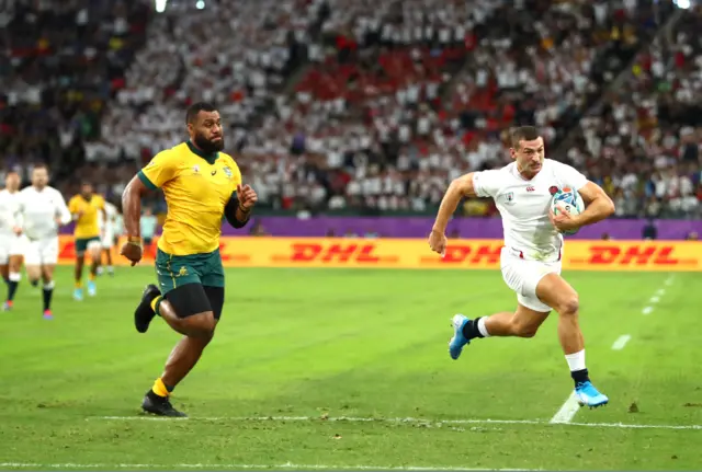 Jonny May of England breaks away to score his team"s second try as Samu Kerevi of Australia chases during the Rugby World Cup 2019 Quarter Final match between England and Australia at Oita Stadium