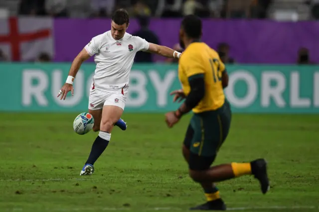 England's fly-half George Ford (L) kicks the ball during the Japan 2019 Rugby World Cup quarter-final match between England and Australia at the Oita Stadium