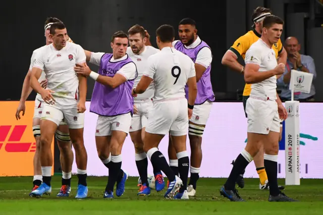 England's wing Jonny May (L) is congratulated by teammates after scoring a try during the Japan 2019 Rugby World Cup quarter-final match between England and Australia at the Oita Stadium in Oita