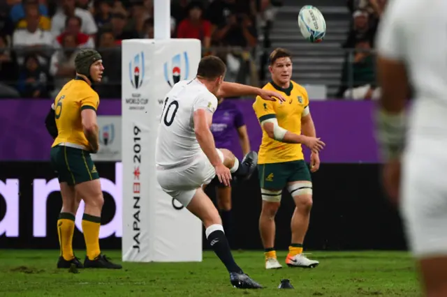 England's fly-half Owen Farrell kicks the ball as Australia's flanker David Pocock (L) and Australia"s flanker Michael Hooper watch during the Japan 2019 Rugby World Cup quarter-final match between England and Australia at the Oita Stadium