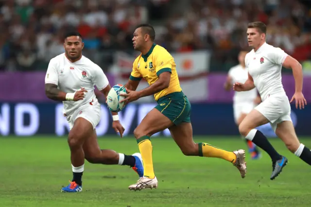 Kurtley Beale of Australia takes on Manu Tuilagi of England during the Rugby World Cup 2019 Quarter Final match between England and Australia at Oita Stadium