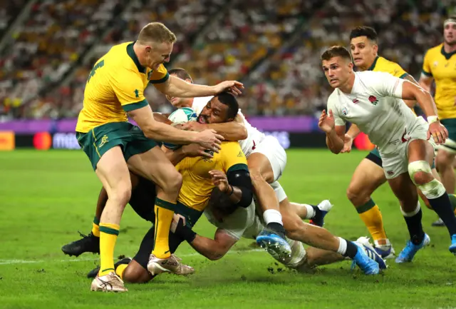 Samu Kerevi of Australia is tackled by Jonny May and Sam Underhill of England during the Rugby World Cup 2019 Quarter Final match between England and Australia at Oita Stadium