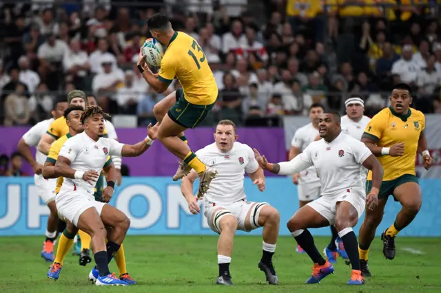 Australia's centre Jordan Petaia (C top) catches the ball in front of England's wing Anthony Watson (L) and England"s flanker Sam Underhill (C) the Japan 2019 Rugby World Cup quarter-final match between England and Australia at the Oita Stadium in Oita