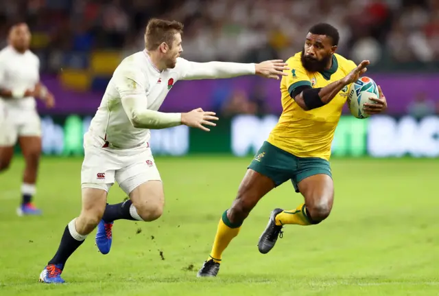 Marika Koroibete of Australia evades Elliot Daly of England as he breaks away to score his team"s first try during the Rugby World Cup 2019 Quarter Final match between England and Australia at Oita Stadium