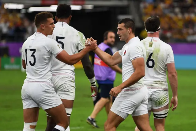 England's wing Jonny May (2nd R) is congratulated by England's centre Henry Slade (L) after scoring a try during the Japan 2019 Rugby World Cup quarter-final match between England and Australia at the Oita Stadium in Oita