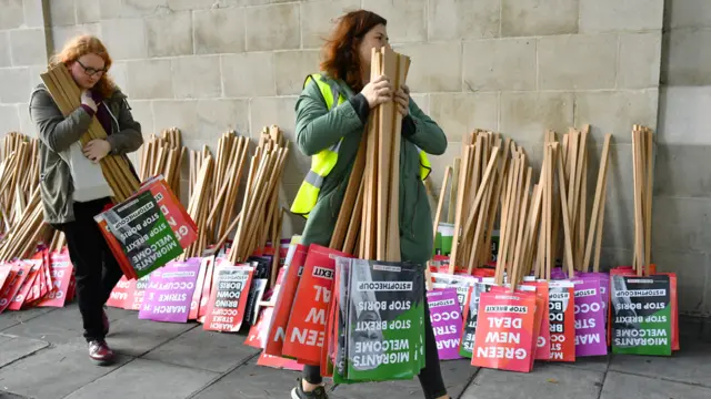 People with placards preparing for the anti-Brexit march later