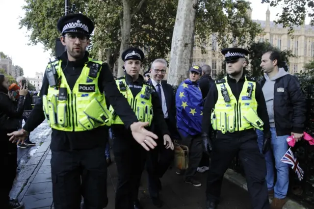 Michael Gove is escorted by police