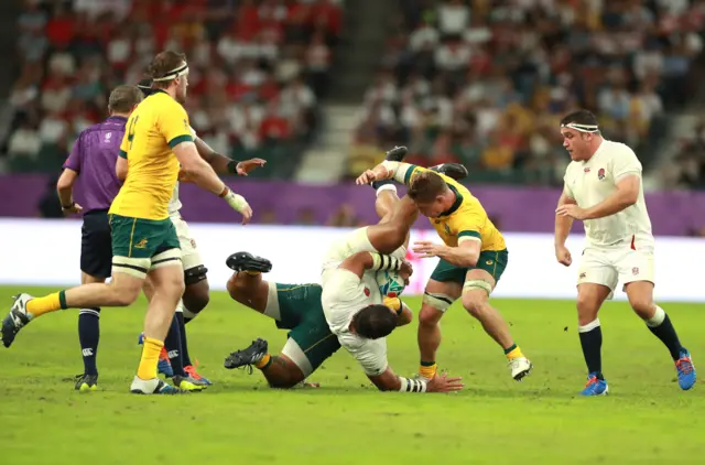 Billy Vunipola of England is tackled by Michael Hooper of Australia during the Rugby World Cup 2019 Quarter Final match between England and Australia at Oita Stadium