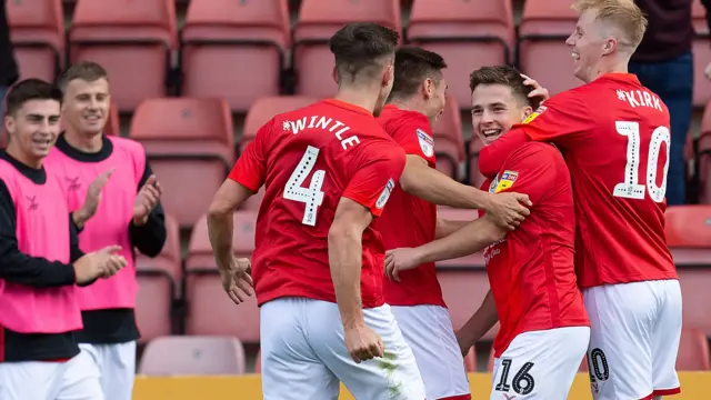 Crewe Alexandra players celebrate scoring a goal