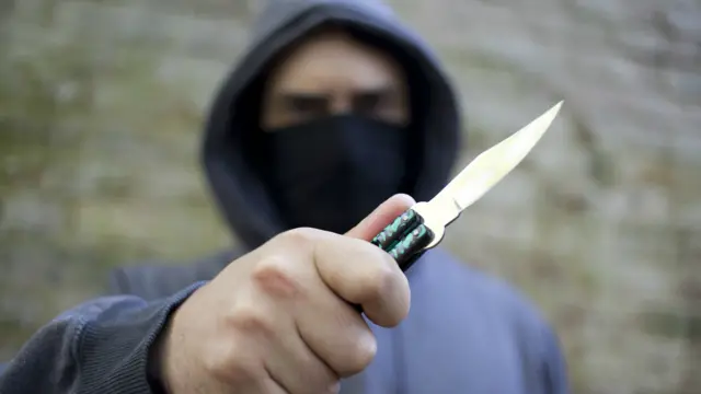 A stock photo of a person with a knife