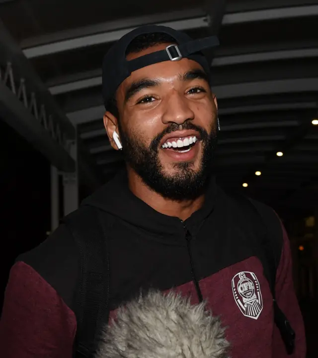 Cluj forward Billel Omrani is all smiles as he arrived at Glasgow Airport