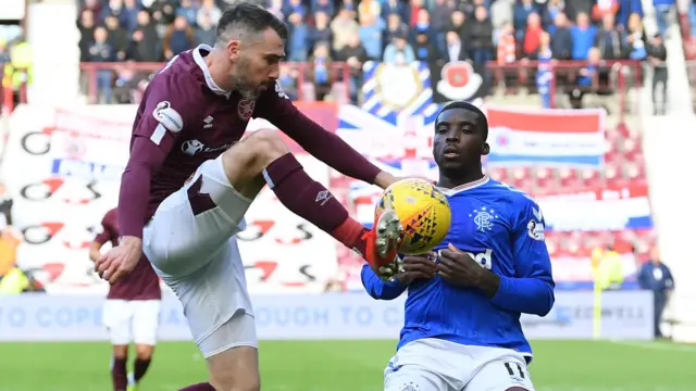 Hearts' Michael Smith (left) battles with Rangers' Sheyi Ojo