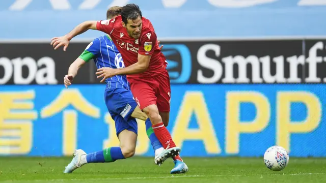 Yuri Ribeiro of Nottingham Forest is tackled by Joe Williams of Wigan Athletic