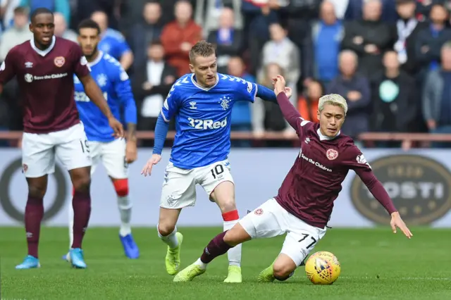 Hearts' Ryotaro Meshino (right) is challenged by Rangers' Steven Davis